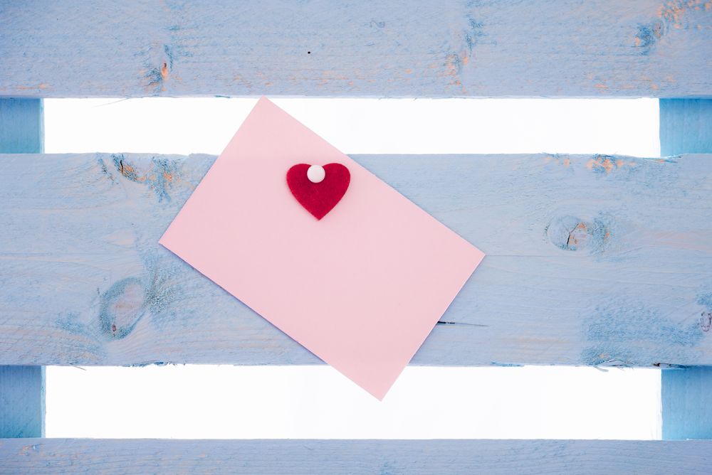 Blank message card with a pinned heart