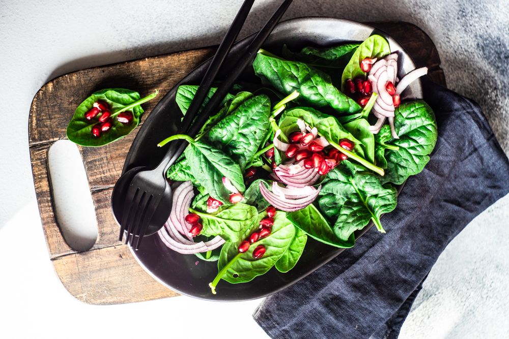 Fresh organic salad with spinach and pomegranate