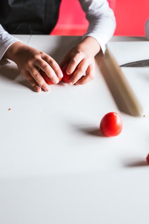 Anonymous boy preparing vegetables for salad