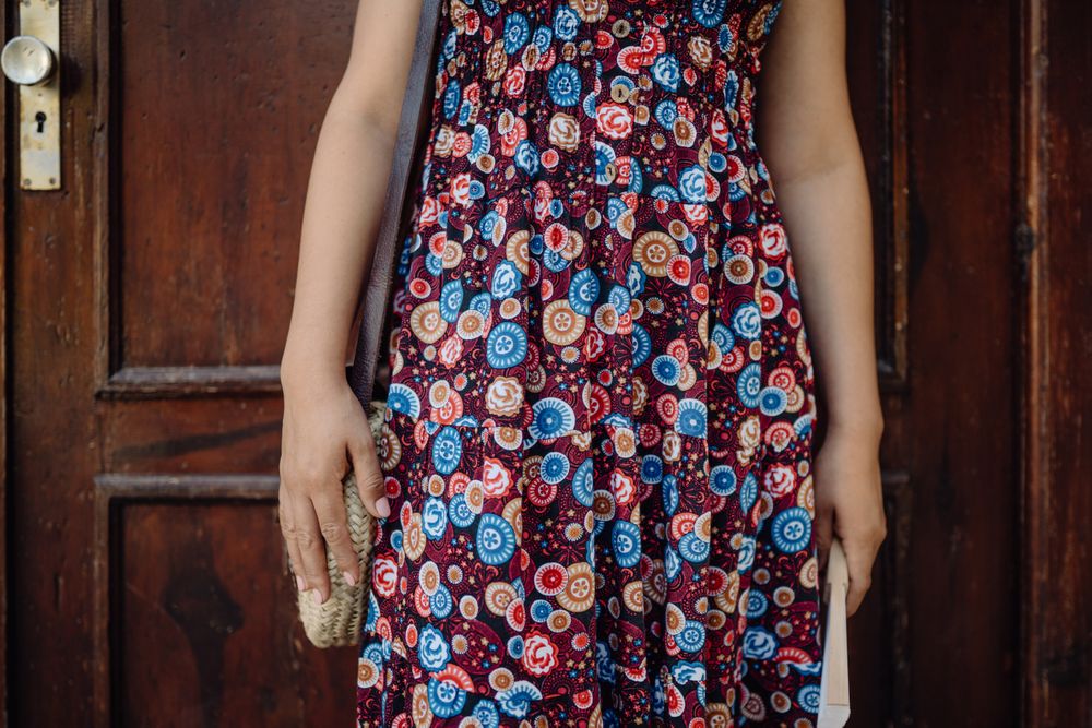crop woman leaning on brown wooden door