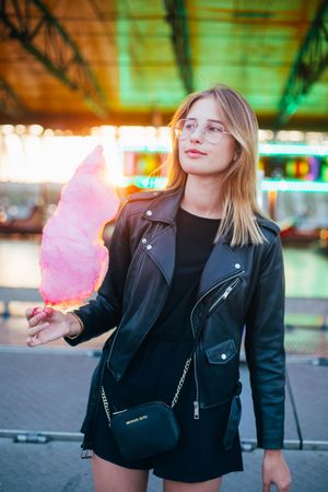 Trendy woman standing in underpass with cotton candy