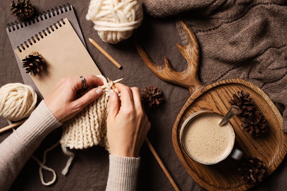 Top view of woman’s hands knitting