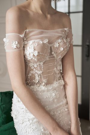 Magnificent pensive young bride in white lace dress looking away and pondering
