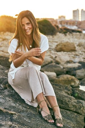 young woman posing on rock
