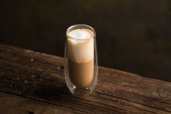Cups of tasty hot coffee drink on wooden table