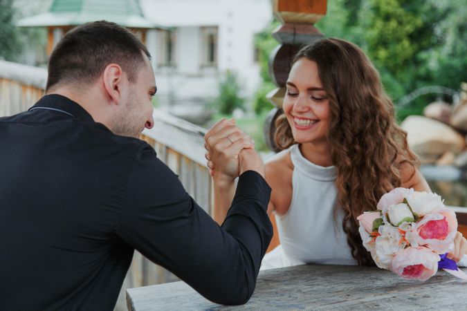 Smiling couple arm battling outdoor