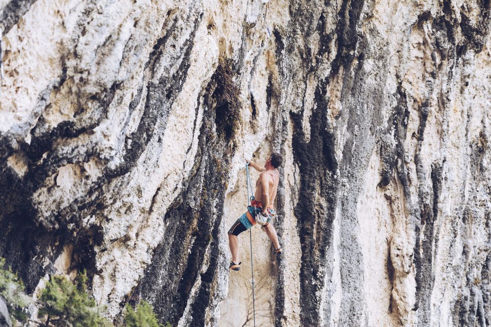 Anonymous man climbing rock