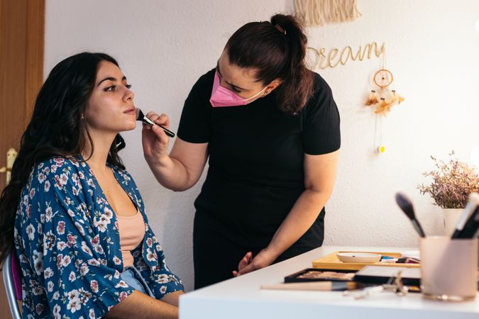 Bride being made up by a professional makeup artist