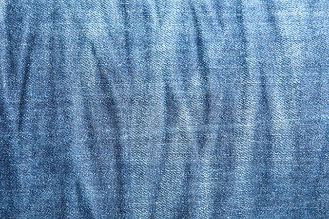 Texture of blue jeans as background, space for text