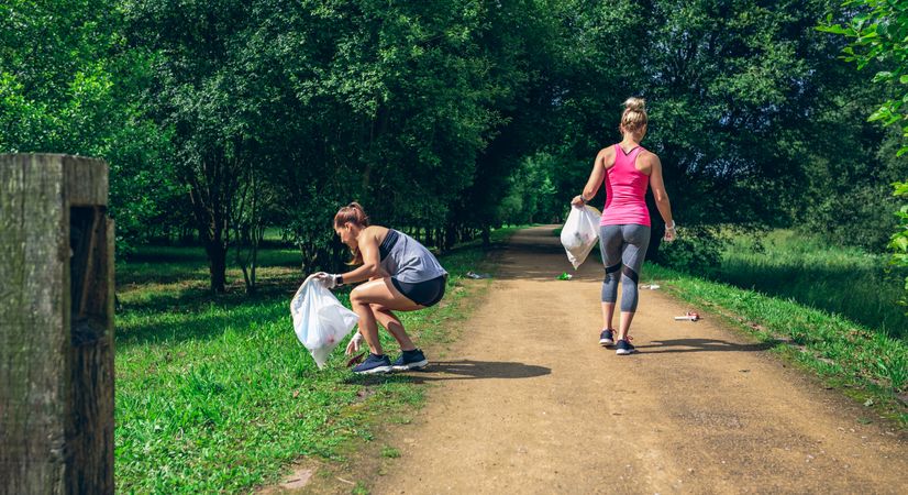 Two females on back doing plogging