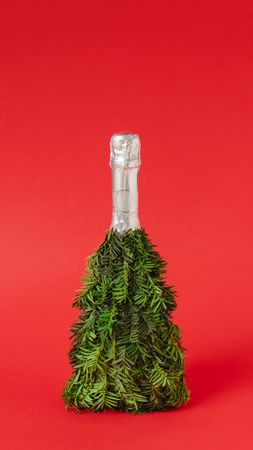Christmas tree trimming on champagne bottle