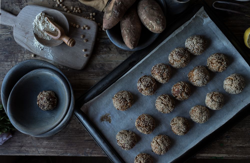 Set of sweet potatoes in sesame seeds on table