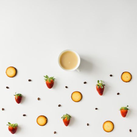 Coffee cup with cookie and strawberry pattern on light background