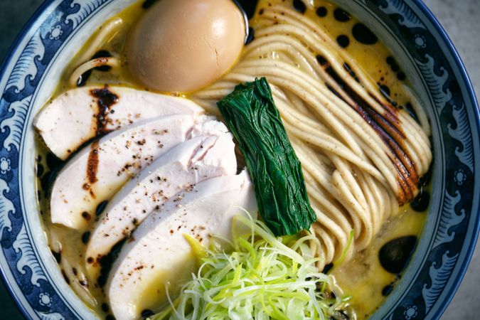 Delicious ramen with chicken fillet slices and seaweed