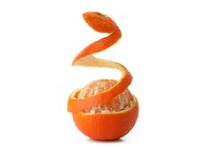 Mandarin with spiral peel isolated on light background