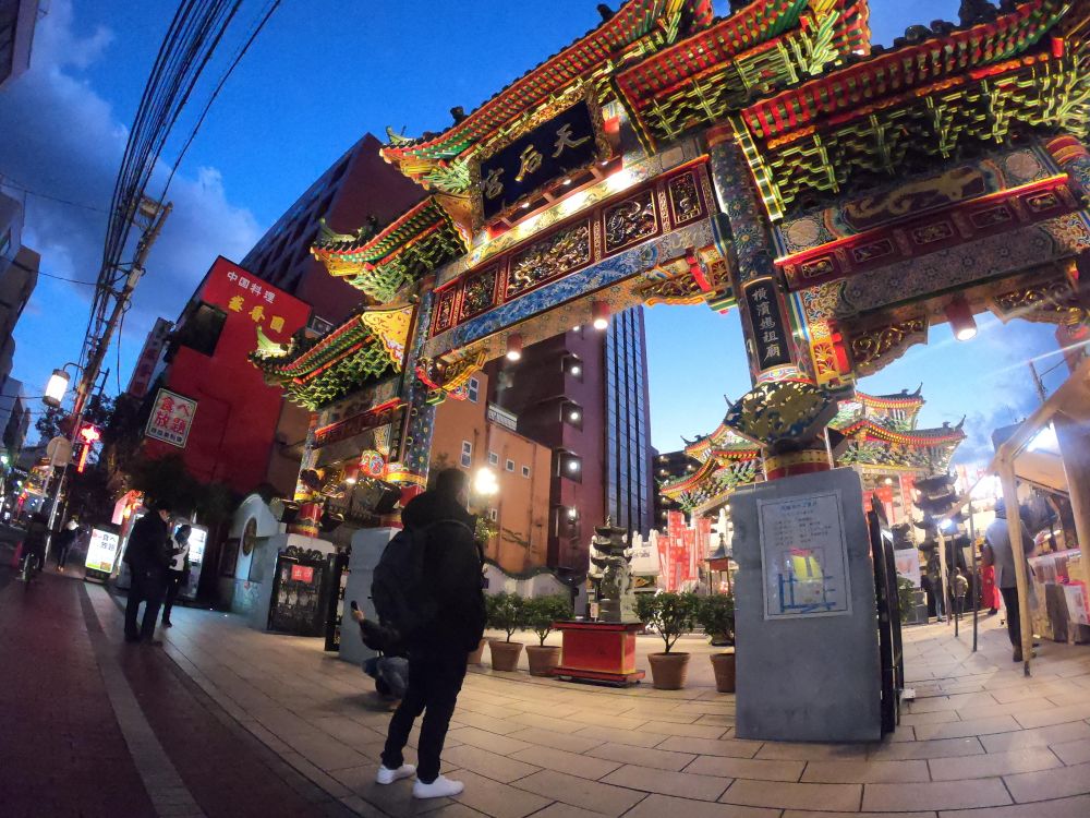 Man standing in front of Yokohama Chinatown