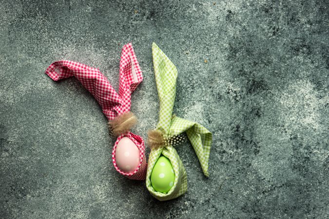 Pink & green egg decorations on grey counter