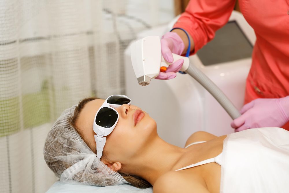 Female with laser hair tool above face