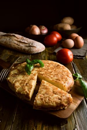 Cooking ingredients around pie on table