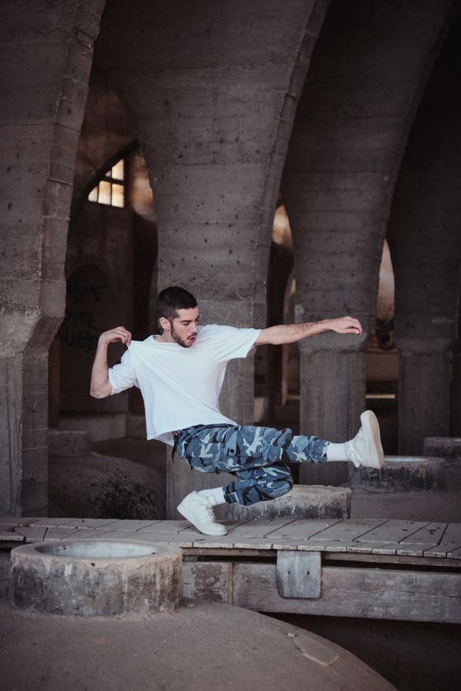 Skillful b boy showing technique in aged cathedral
