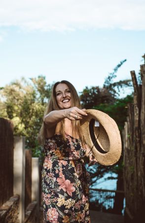 Cheerful woman in summer dress spinning around