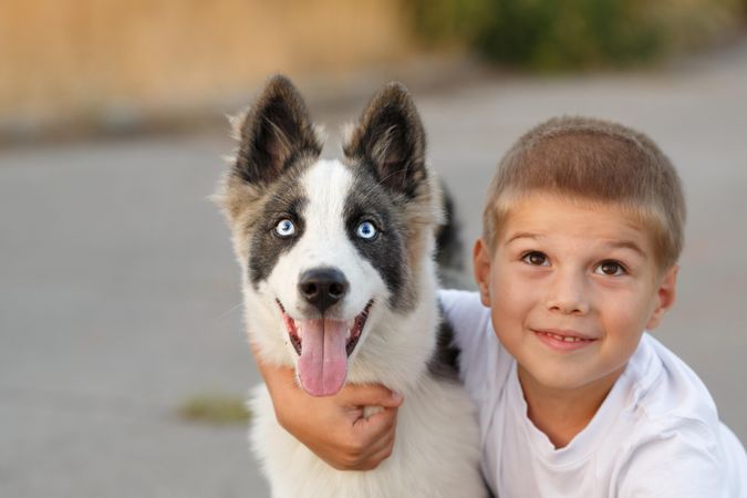 Happy young male with husky dog