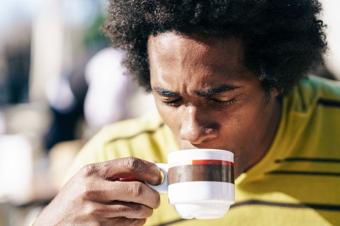 Man sipping coffee in the sun