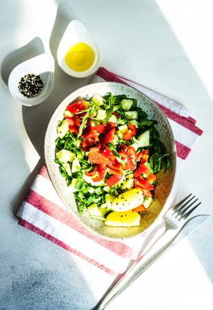 Top view of big grey bowl of healthy tomato salad