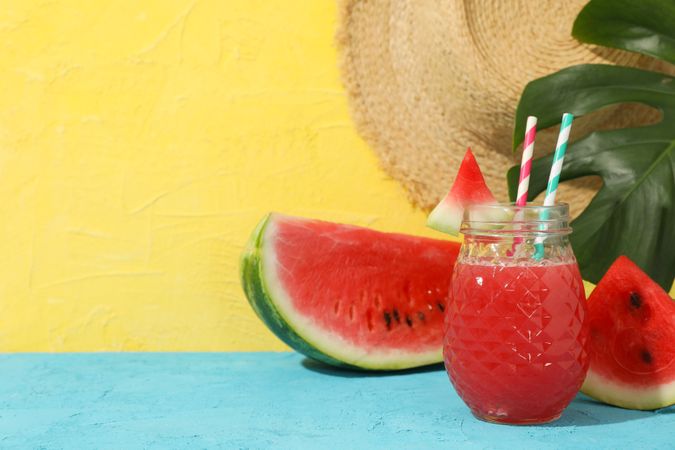 Composition with watermelon juice on blue table. Summer fruit