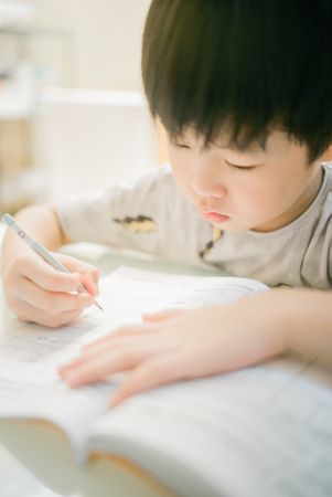 Boy writing in notebook