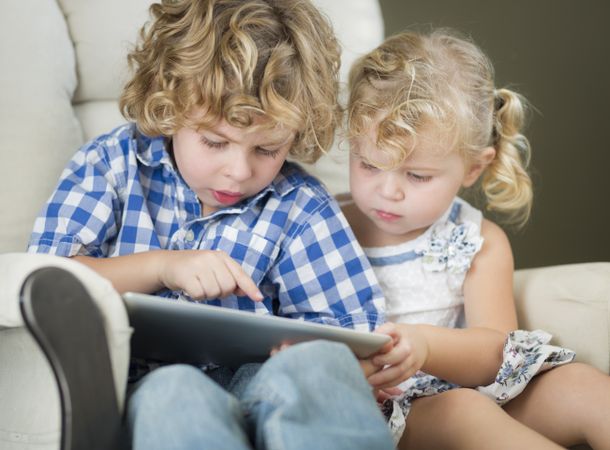 Little Brother and Sister Using Their Computer Tablet Together