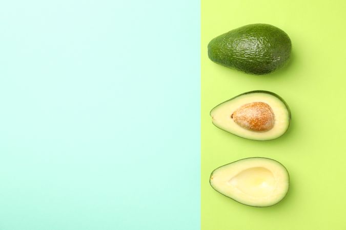 Ripe fresh avocado on two tone background, top view