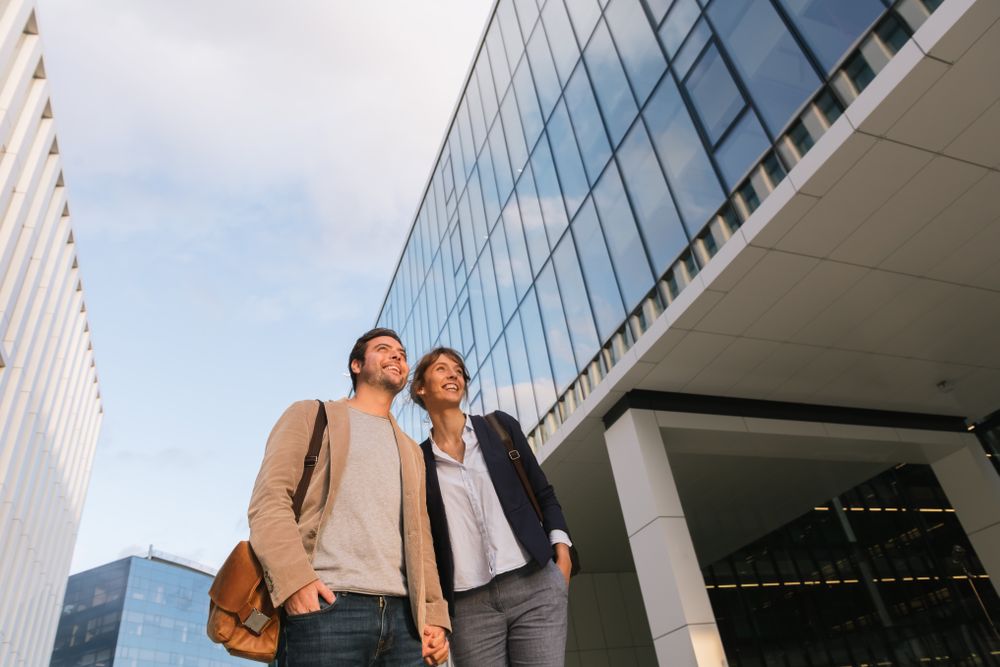 Businesspeople couple outside contemporary building