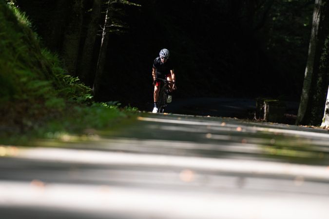 Professional cyclist riding bike in park