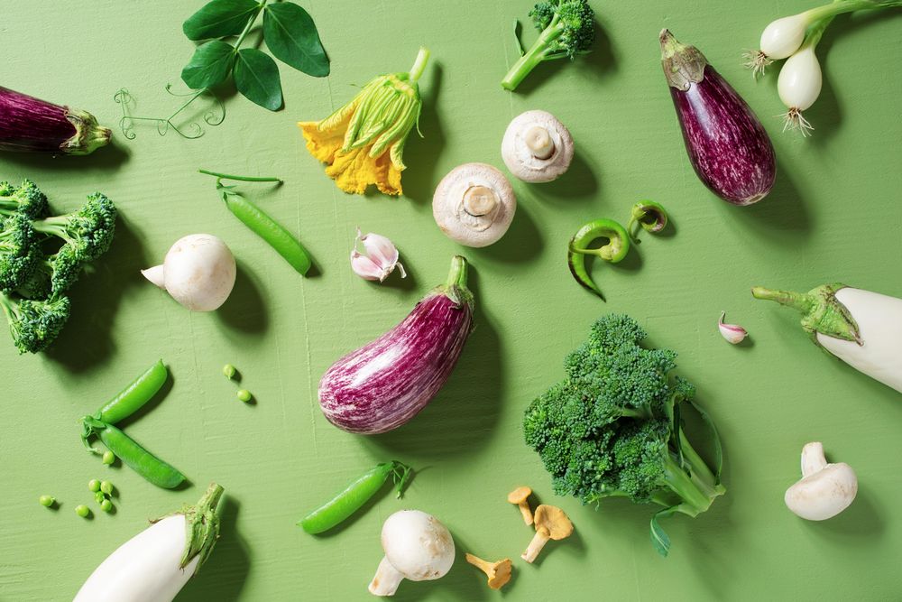 Top view of fresh raw vegetables on green table