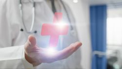 Doctor holding medical cross hologram