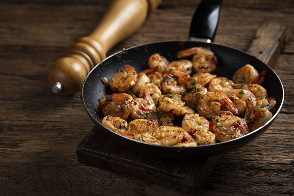 Delicious grilled prawns on wooden background.
