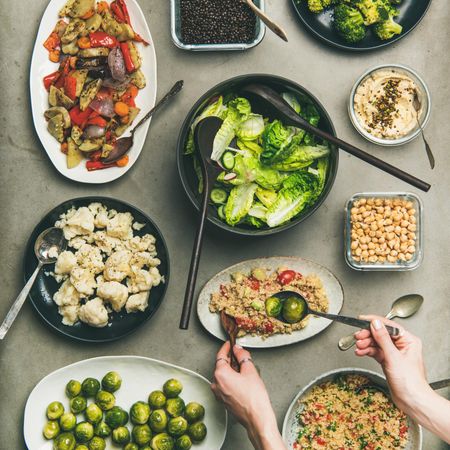 Flat-lay of vegetable salads of healthy dishes in plates on table