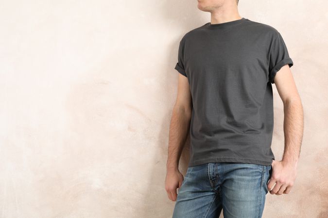 Men in blank grey t-shirt against color background, space for text