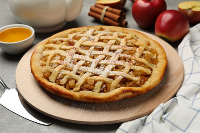 Composition with apple pie and ingredients on gray background. Homemade food