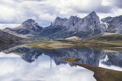 Cloudy sky over calm lake and mountains