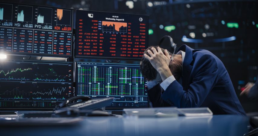 Financial Crisis Concept with Stock Broker Saddened by Negative Ticker Information, Red Graphs and Real-Time Data