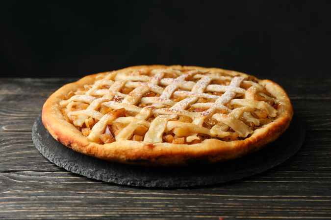 Tasty apple pie on wooden background. Homemade food