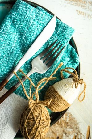 Close up of Easter table setting with teal napkin and eggs