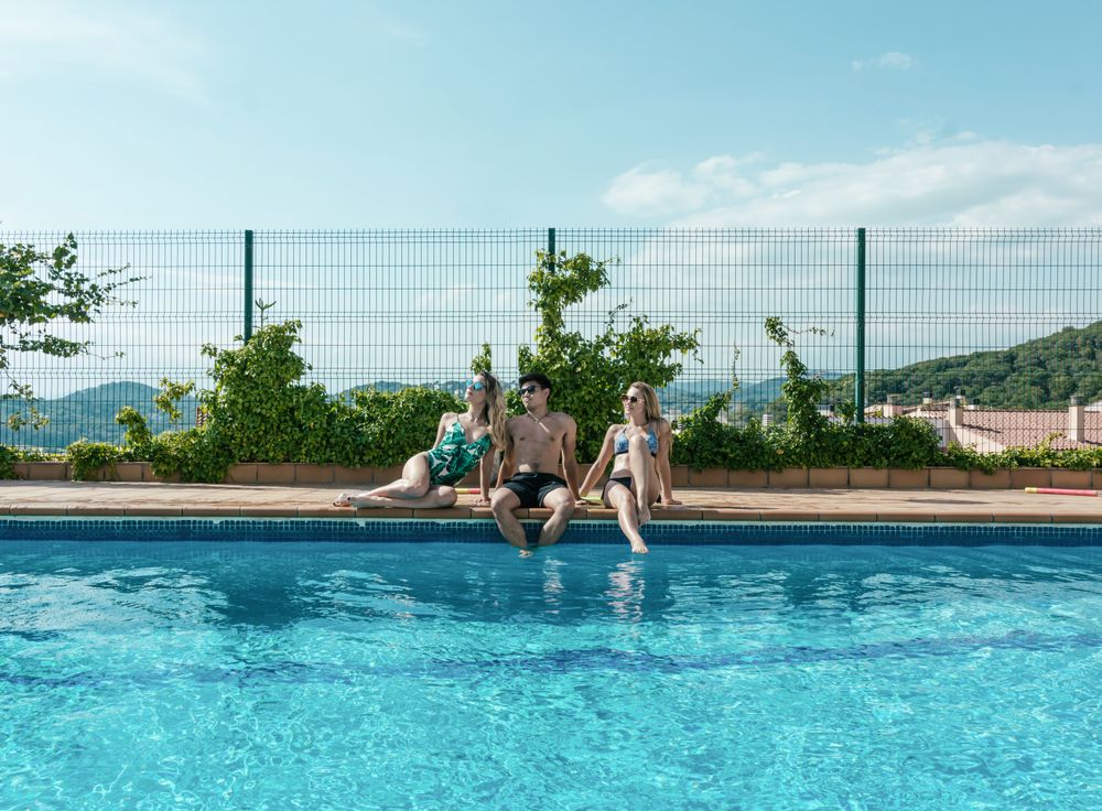 Friends playing with water pistols in the pool
