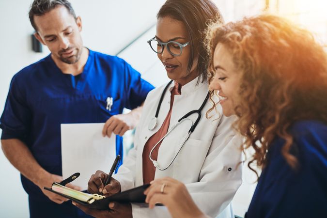 Group of medical staff looking over a chart