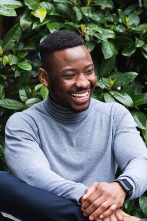Happy Black man in casual wear looking away