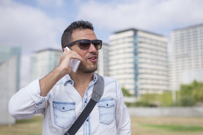 Content man having conversation on cell phone outside