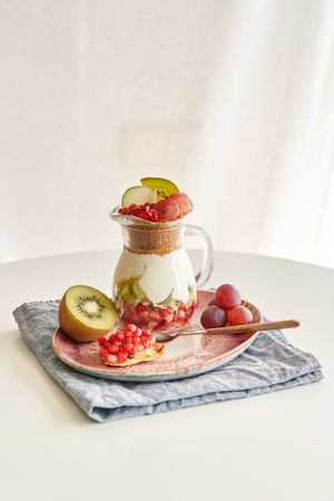 Delicious yogurt dessert with pomegranate, kiwi, grape and ginger biscuit