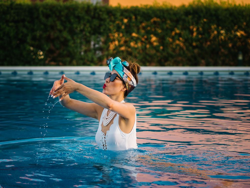 Young elegant Chinese woman relaxing inside a pool